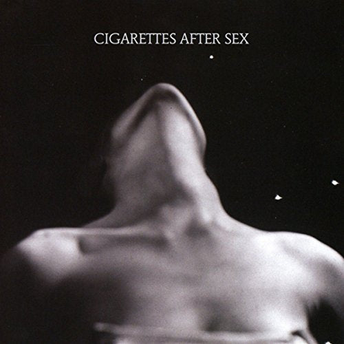 Black and white album cover with a blurred image of a person’s neck and shoulders.