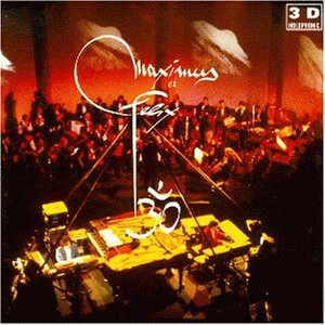 Orchestra performing with a pianist in a warmly lit, reddish stage.
