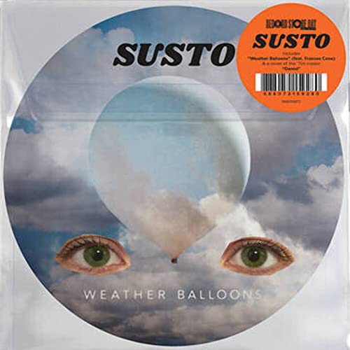 Vinyl record with cloudy sky, large eye image, and orange sticker.