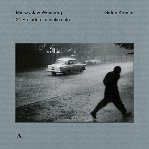 CD cover: black and white photo of a car and walking figure.