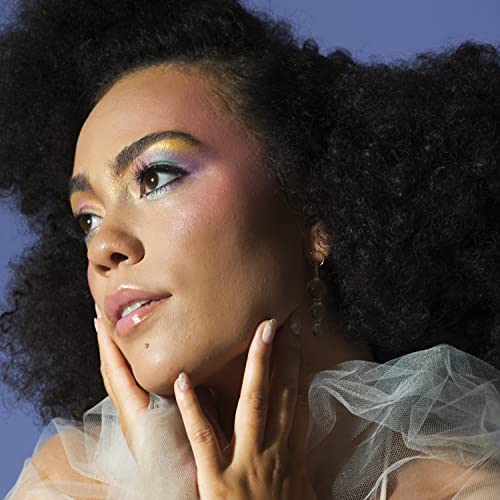 Close-up portrait of Madison McFerrin with colorful eye makeup and curly hair.