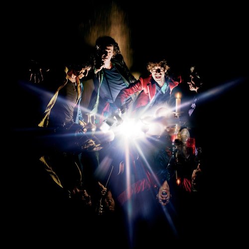 The Rolling Stones album cover, featuring the band in a dark, lit scene.