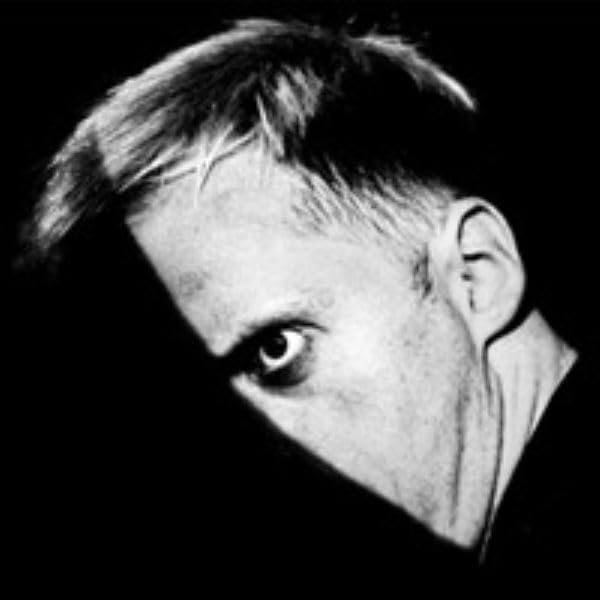 Black and white portrait of a man with intense gaze, side profile.
