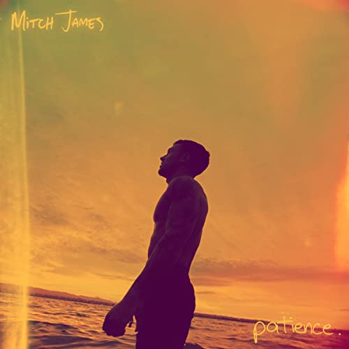 Silhouetted man facing ocean at sunset, album cover for Mitch James’ “Patience.”