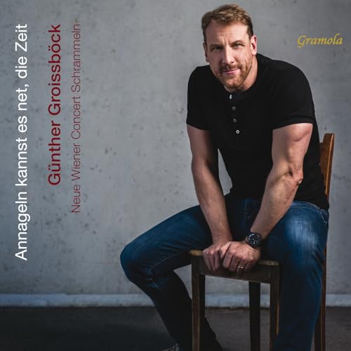 CD cover featuring a man in a black shirt and jeans, seated.