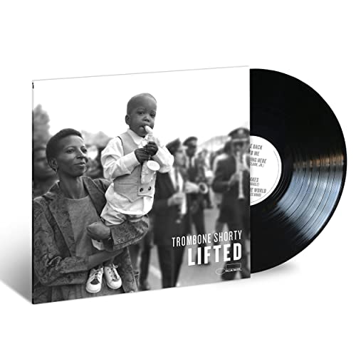Vinyl record with cover depicting a child on shoulders playing trombone.