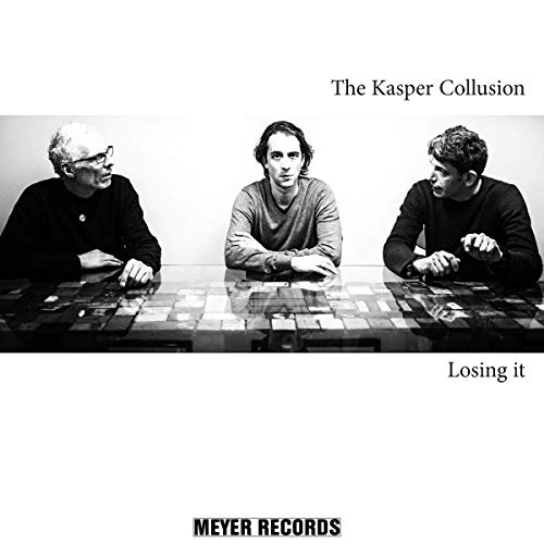 Black and white photo of three men seated at a reflective table.