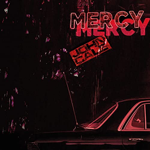 John Cale’s “Mercy” album cover: red neon text over a dark, rainy car.