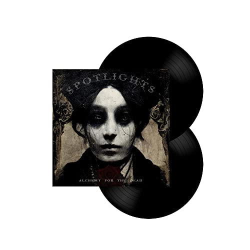 Two black vinyl records with cover art featuring a pale, haunting portrait.