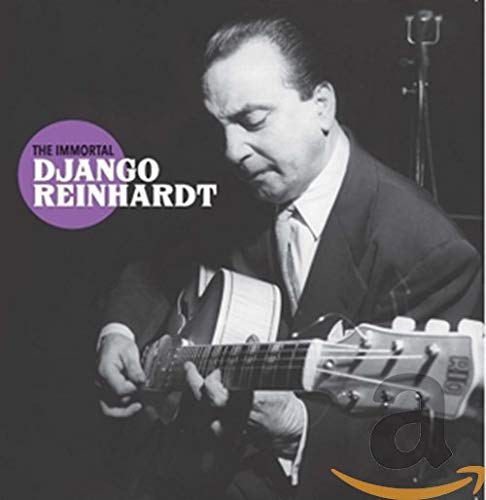 Black and white photo of Django Reinhardt playing an acoustic guitar.