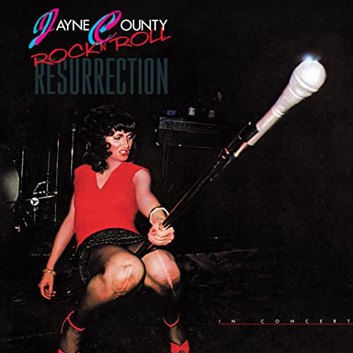 Album cover: Jayne County holding a microphone stand, concert background.