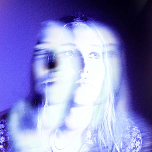 Blurred portrait of a woman with long hair, in blue tones.