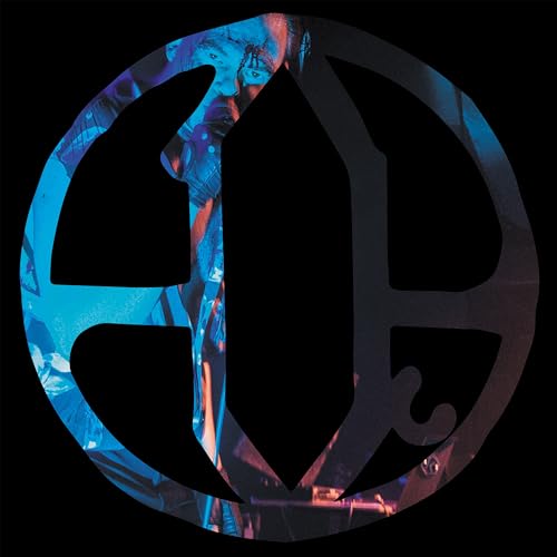 Circular album art with a distorted face and large black letter “Q”.