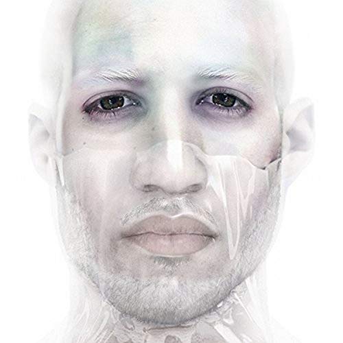 Close-up portrait of a man with a partially obscured face, pale skin.
