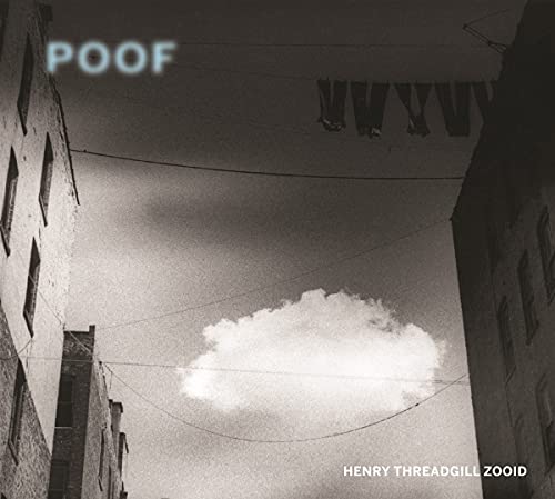 Black and white album cover with buildings, clouds, and hanging fabric.