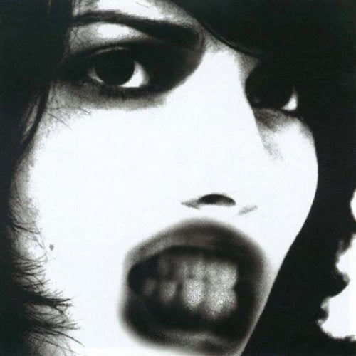 Black and white close-up of a woman’s face, partially blurred.