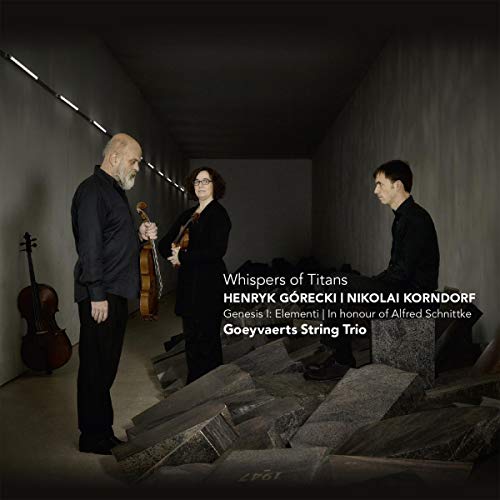 Three musicians with string instruments stand in a stone corridor.