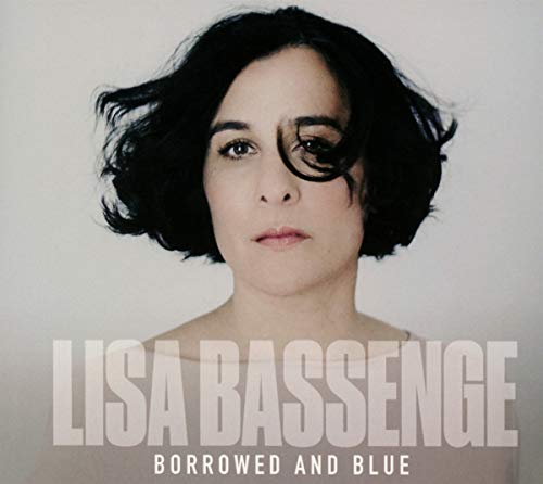Portrait of Lisa Bassenge with dark hair and bold eye makeup.