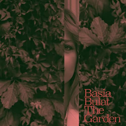 Vinyl album cover featuring a woman partially obscured by foliage.