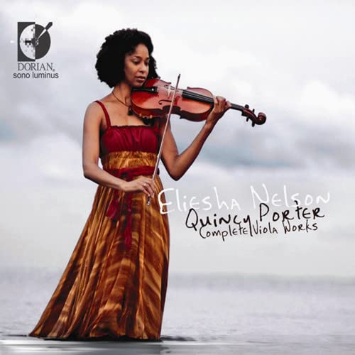 Violist Eliesha Nelson playing a brown viola against a blurred seascape.