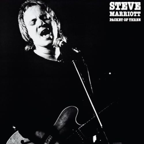 Black and white portrait of Steve Marriott singing into a microphone.