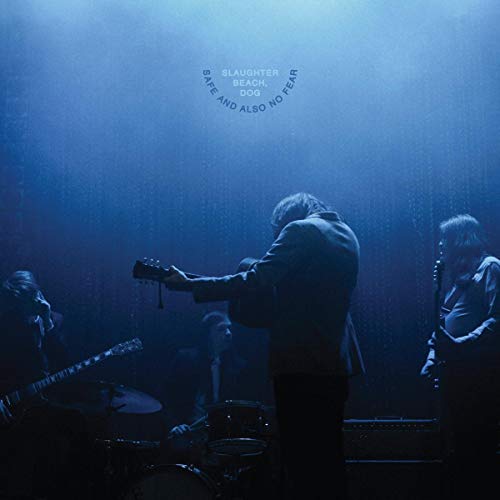Band performing on stage, bathed in blue light, album cover art.