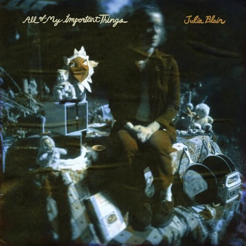 Album cover for Julia Blair’s “All Of My Important Things” featuring a person and toys.