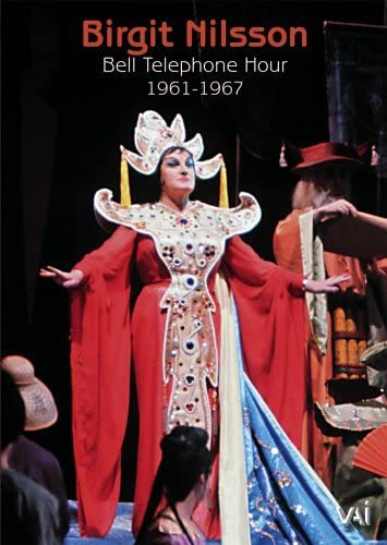 Birgit Nilsson in red costume with elaborate headpiece, stage performance.