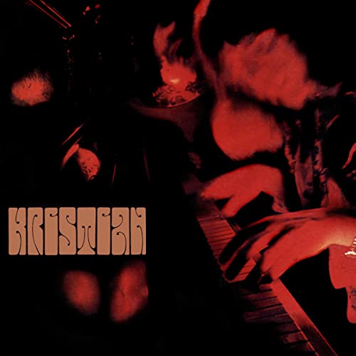 A person plays a piano in a dark, red-tinted scene with stylized text reading Kristian.