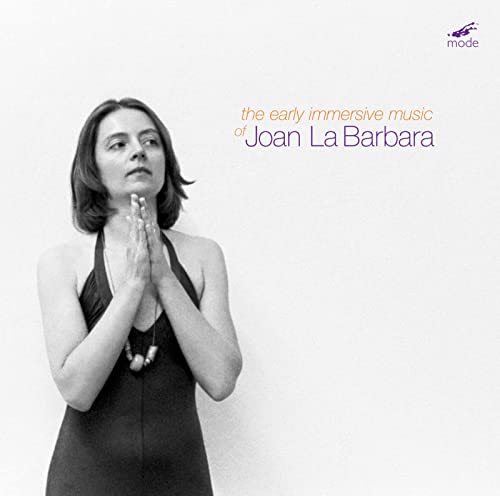 Black and white portrait of Joan La Barbara, hands near face, CD cover.