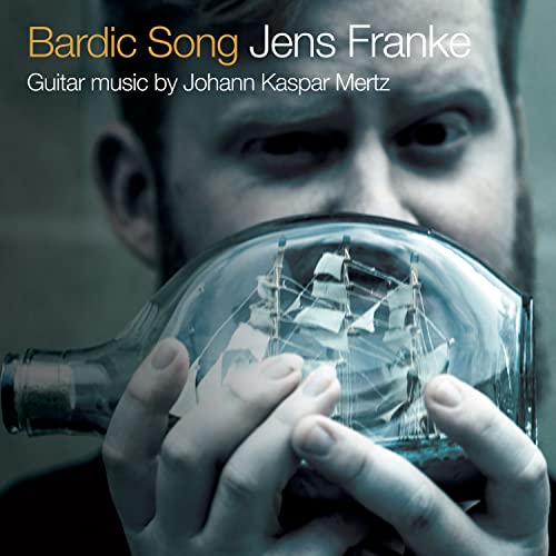 CD cover: man holding a ship-in-a-bottle, blue and grey tones.