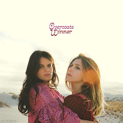 Album cover for Overcoatsā āWinnerā featuring two women in a desert landscape.