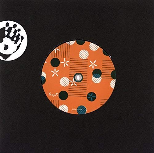 Orange vinyl record label with polka dots and geometric patterns.