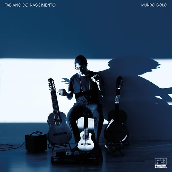 Fabiano Do Nascimento seated with guitars, album cover for "Mundo Solo.