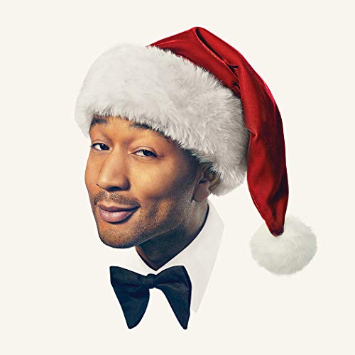 John Legend wearing a Santa hat and black bow tie.