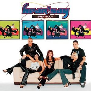 Hearsay band members posing on a cream couch with colorful square images above.