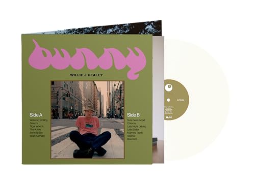 Green album cover with pink text and photo of a man sitting on sidewalk.