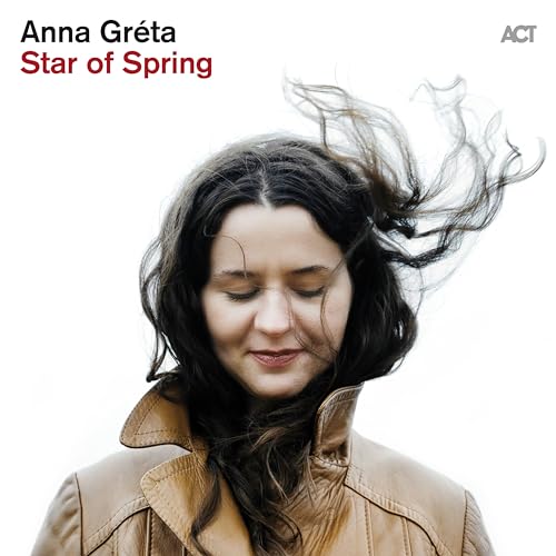 CD cover featuring a woman with dark, windswept hair, eyes closed.