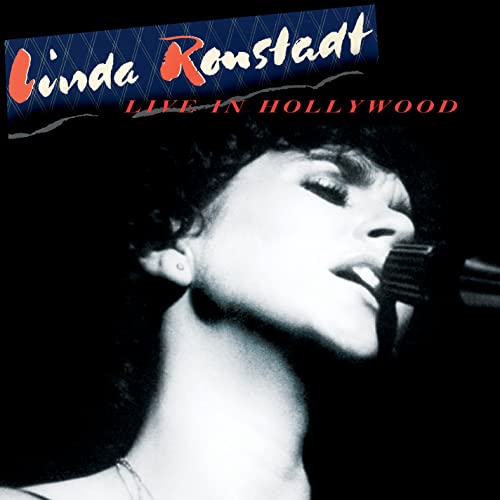 Linda Ronstadt singing into a microphone on album cover.