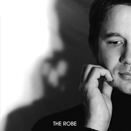 Black and white portrait of a man with hand to chin, album cover.