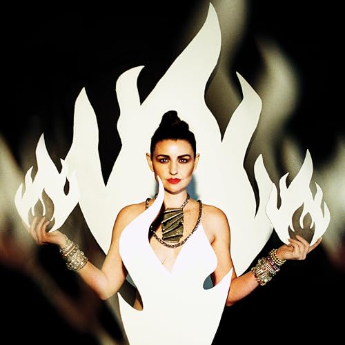 Woman with updo framed by white flames, wearing a necklace and bracelets.