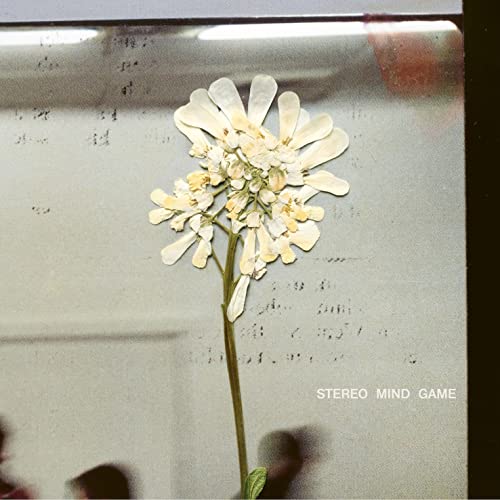 CD cover with a white flower against a gray, textured background.