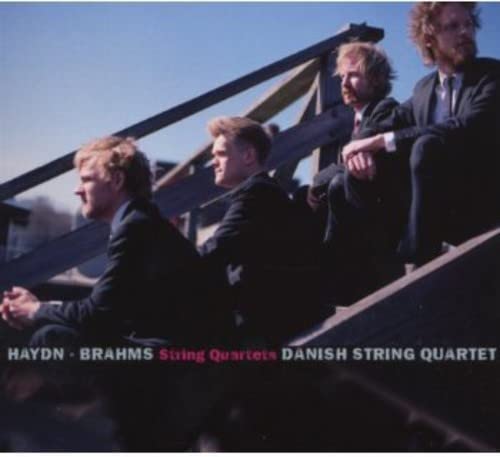 Four musicians of the Danish String Quartet in a dark portrait.