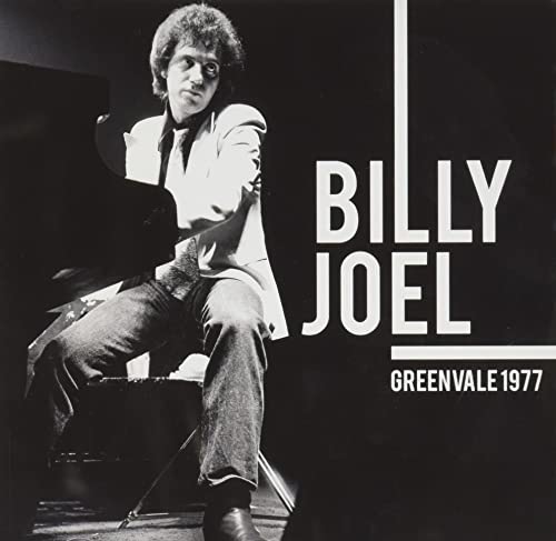 Black and white photo of Billy Joel seated at a piano, album cover.