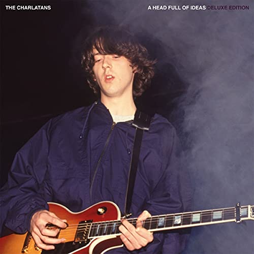 Man playing a red electric guitar, album cover for The Charlatans.