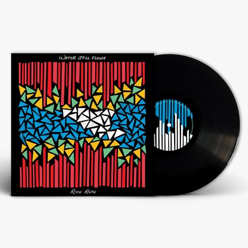 Vinyl record with colorful geometric album art and black center label.