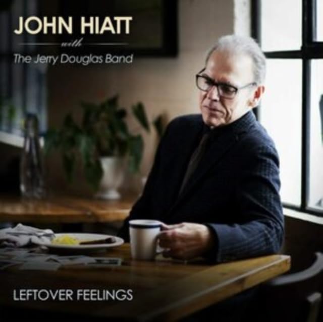 John Hiatt portrait on album cover, with coffee cup and window backdrop.