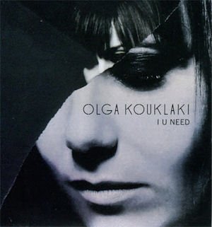 Close-up portrait of Olga Kouklaki with album title “I U NEED”.