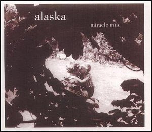 CD cover for Alaska’s “Miracle Mile” featuring a couple embracing in snow.