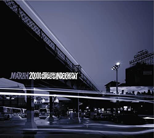 Album cover: Elevated train tracks over a city street at dusk.